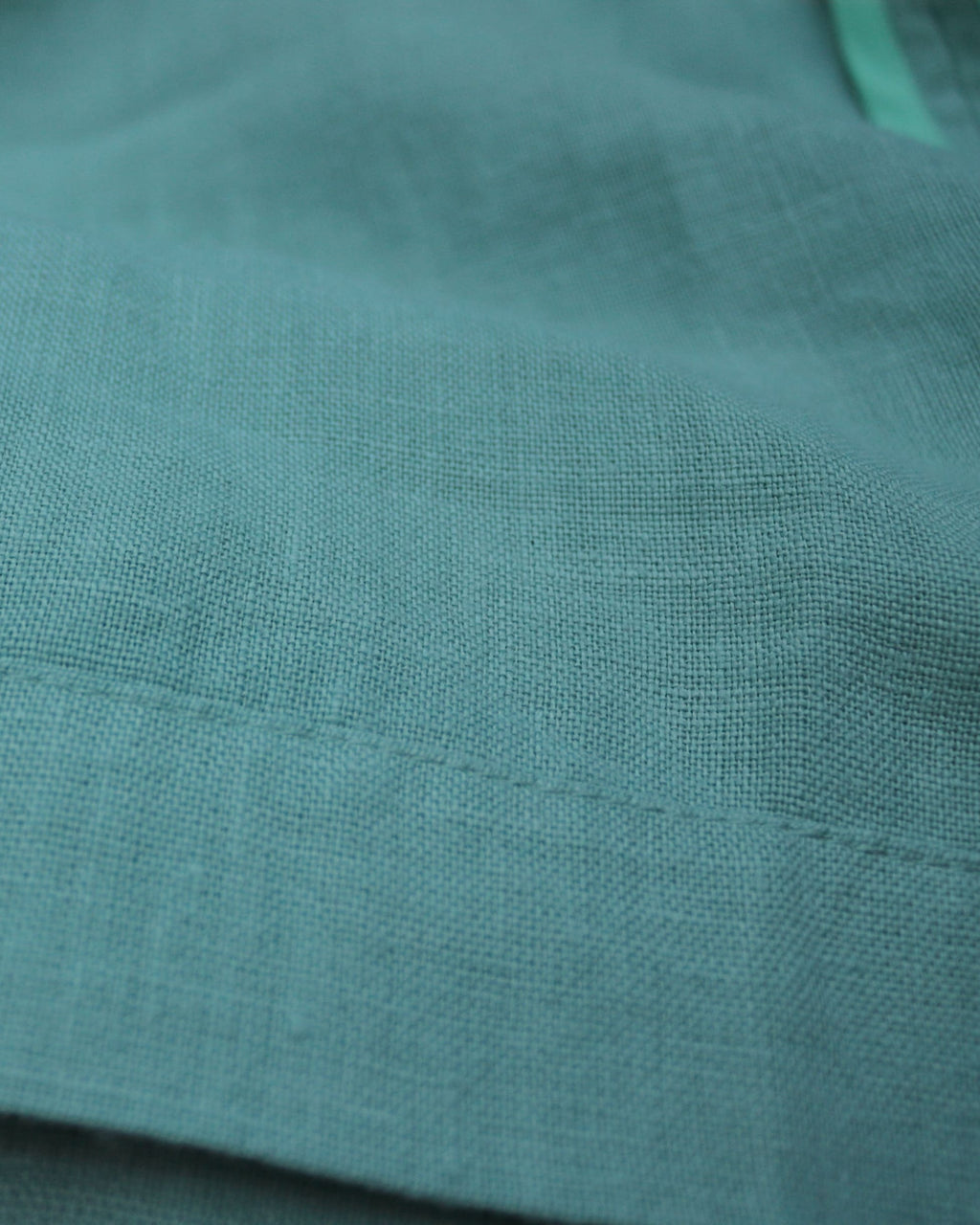 European linen fabric seams in meadow green