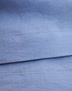 Seams detail on light blue linen dress