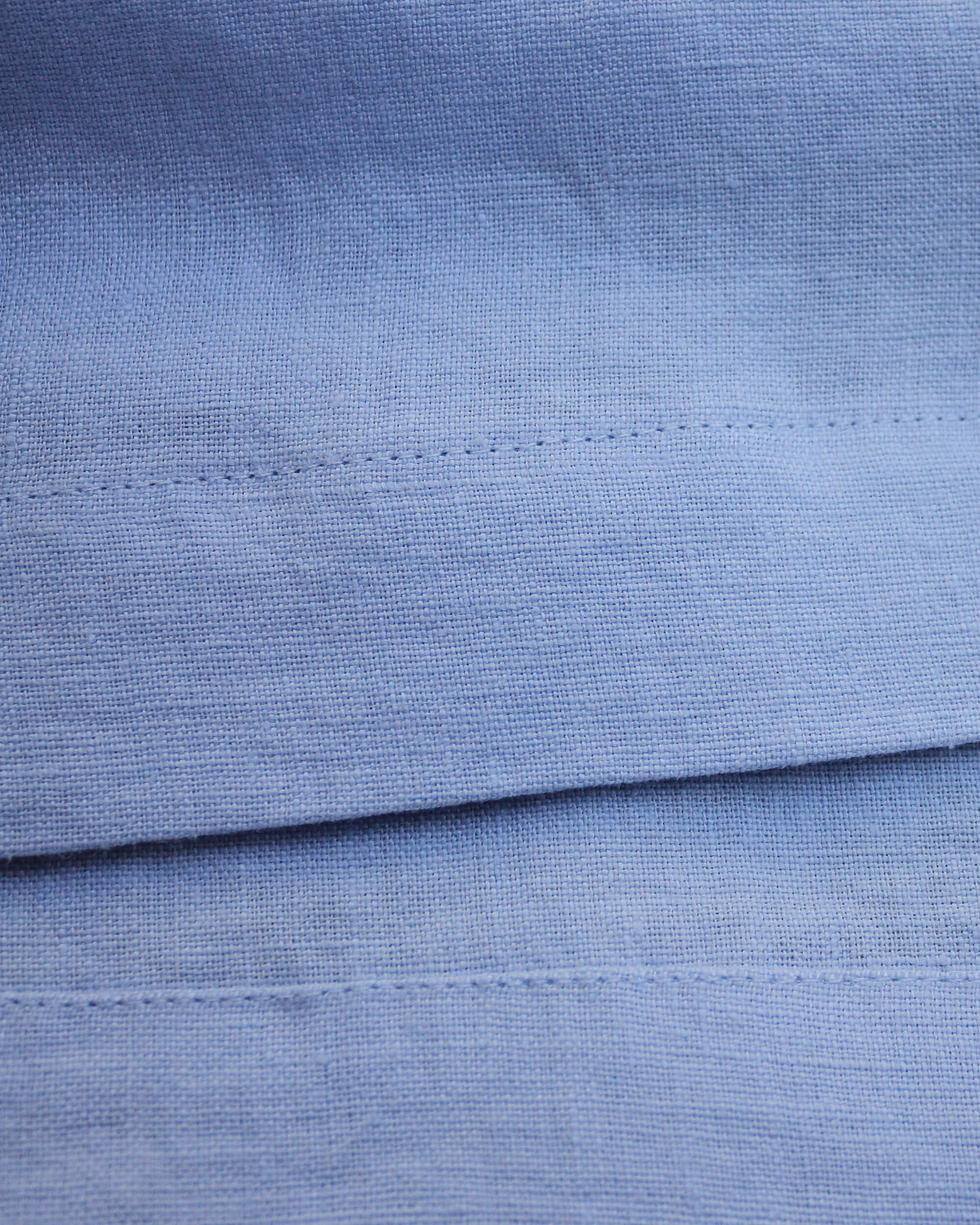 Seams detail on light blue linen dress